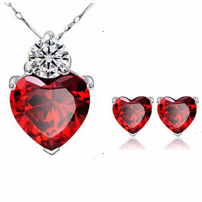 Bridal Jewelry Set Earrings Necklace featuring red heart-shaped gemstones and a sparkling pendant, perfect for wedding accessories.